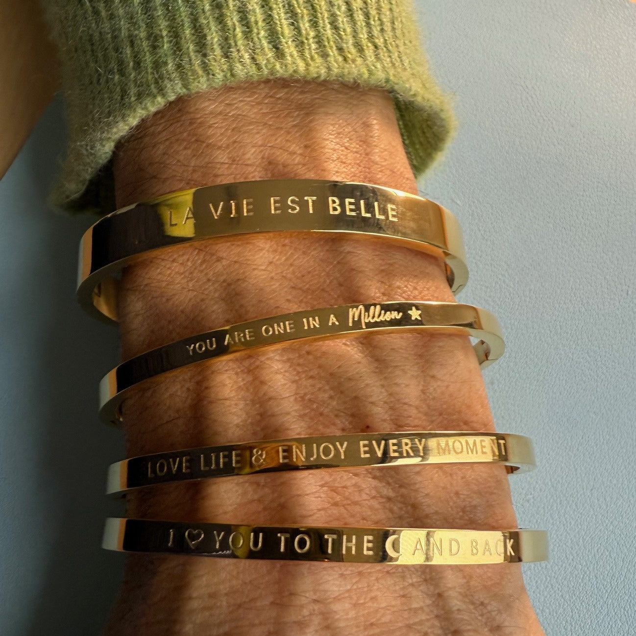 Gold bangles for the wrist which
have fun phrases engraved on them and are thin or thicker