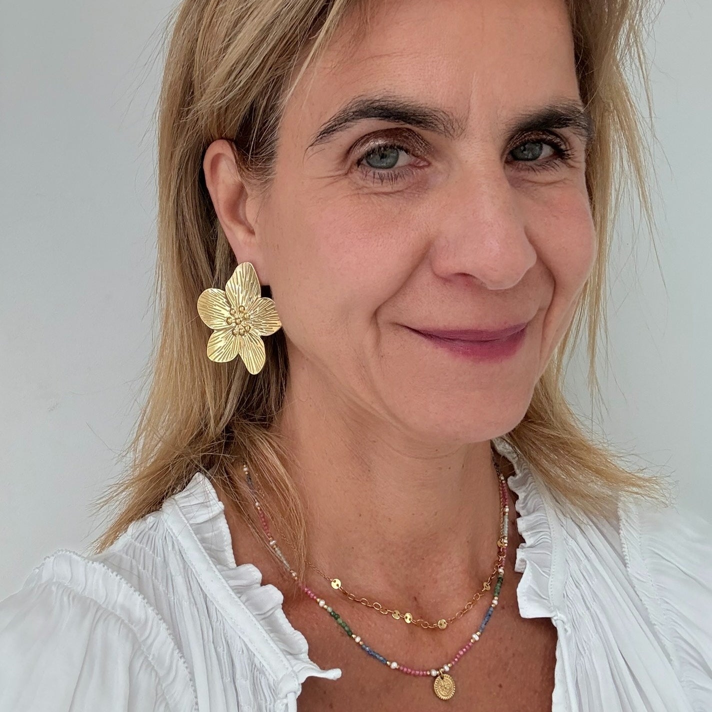 big flower stud earrings 50mm in size worn on model