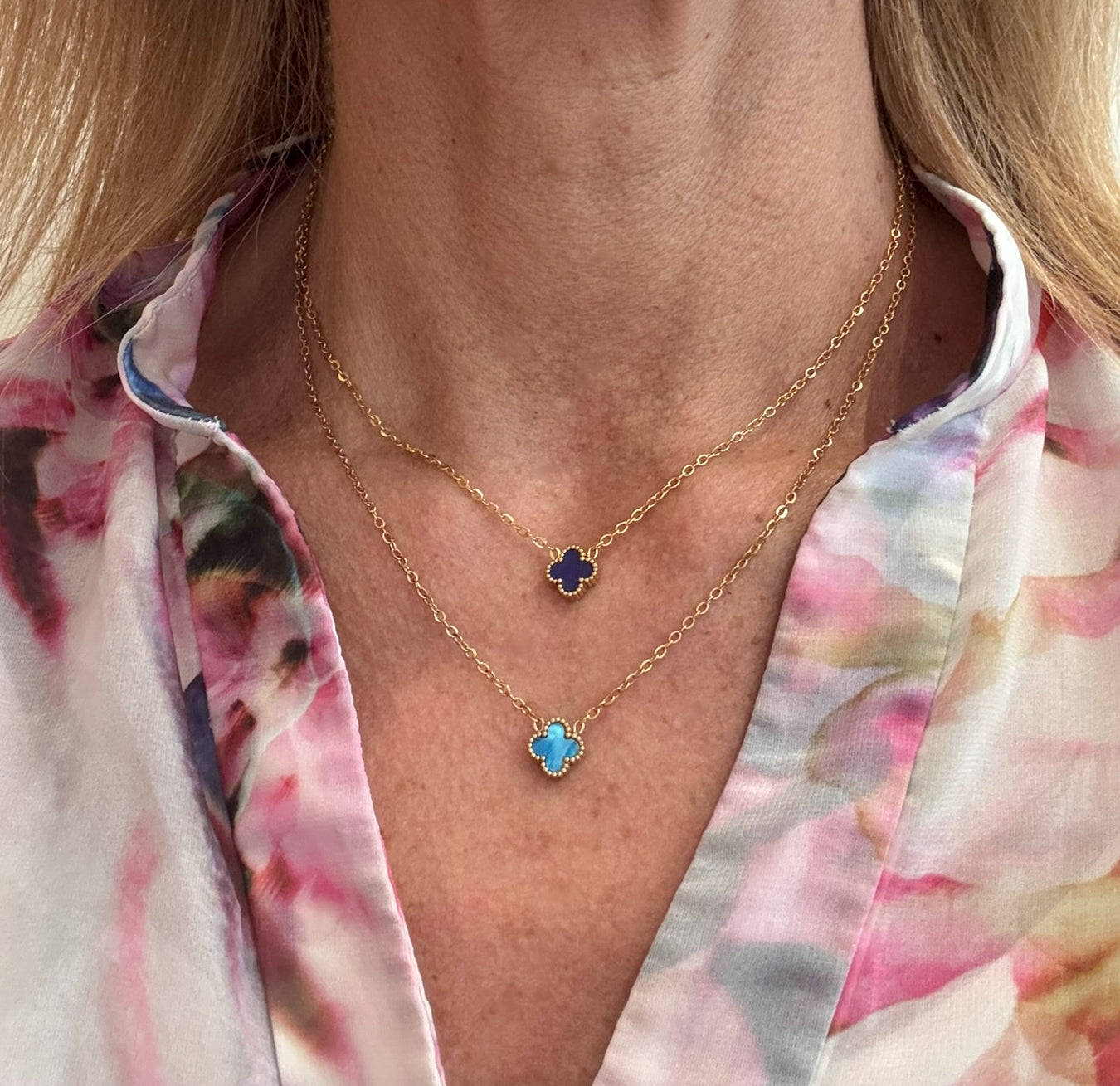 Two gold chain necklace with tiny 9mm  charms in blue and dark blue worn on model