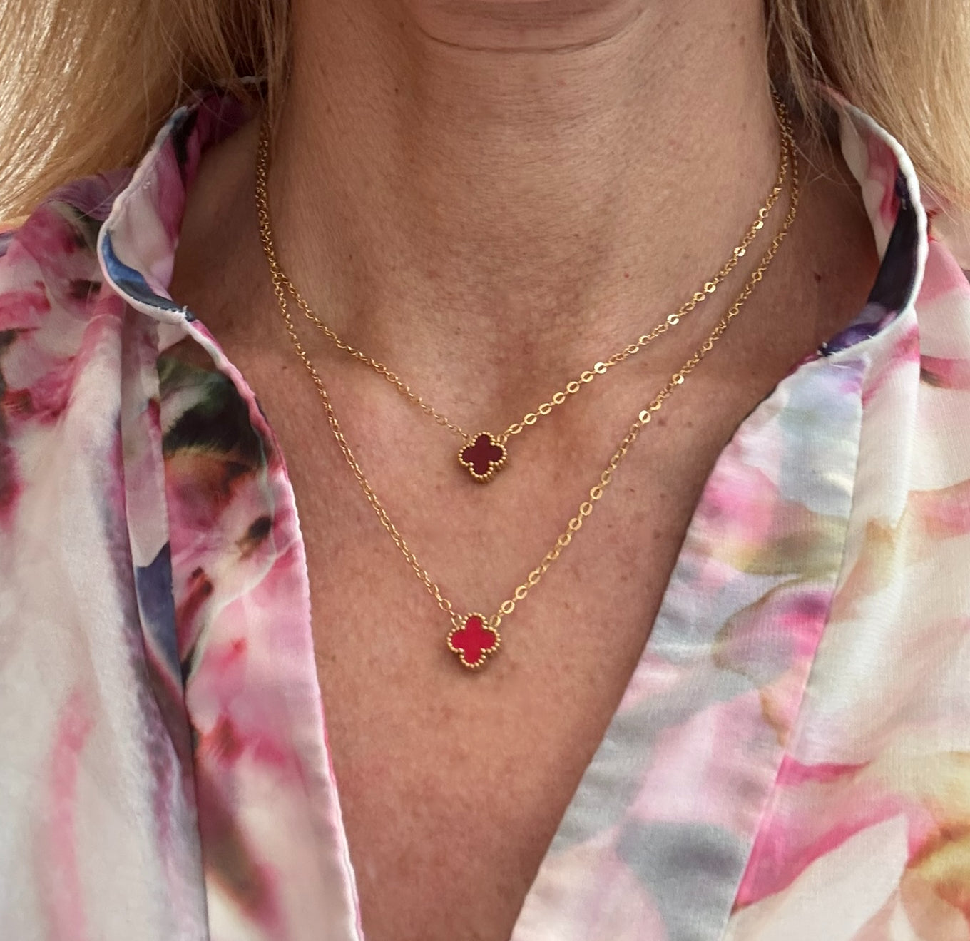 Two gold chain necklace with tiny 9mm  charms in burgundy and red worn on model