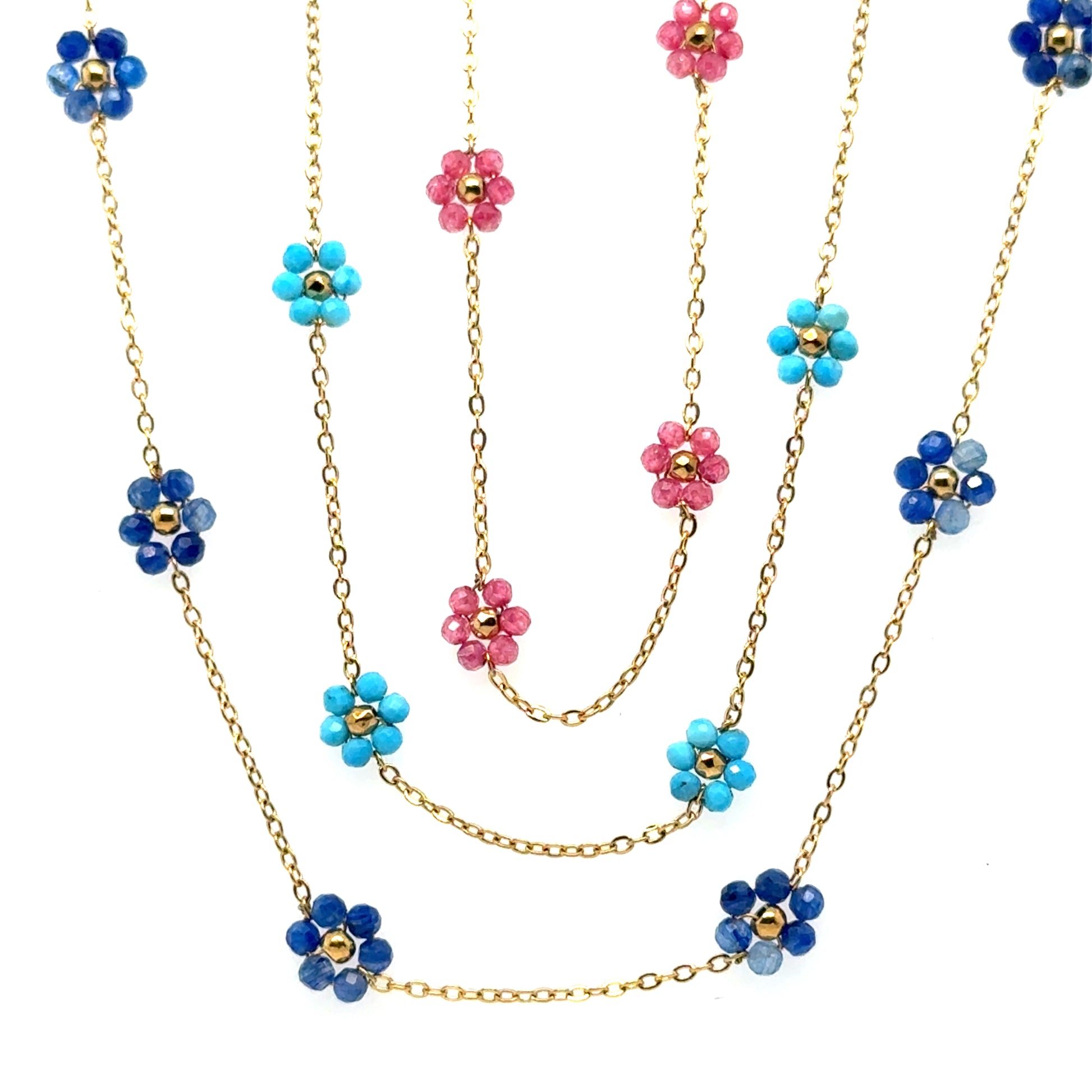 Three necklaces with five small flowers in either dark blue, turquoise or pink on a delicate gold chain