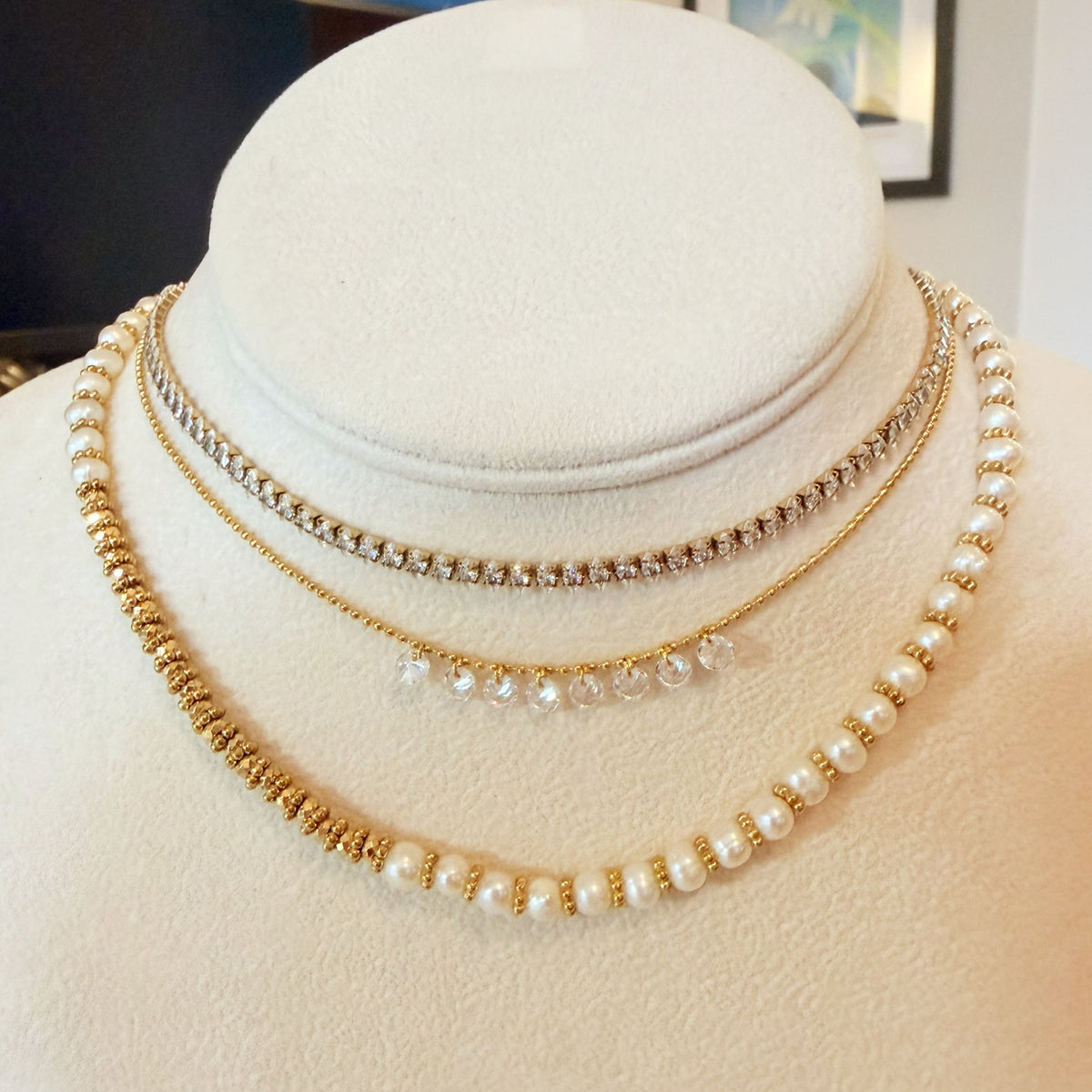 Three gold necklaces with sparkles and pearls