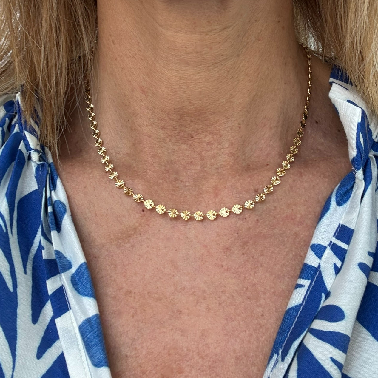Patterned small disc chain necklace worn on model