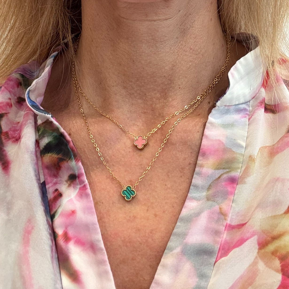 Two gold chain necklace with tiny 9mm  charms in green and pink worn on model