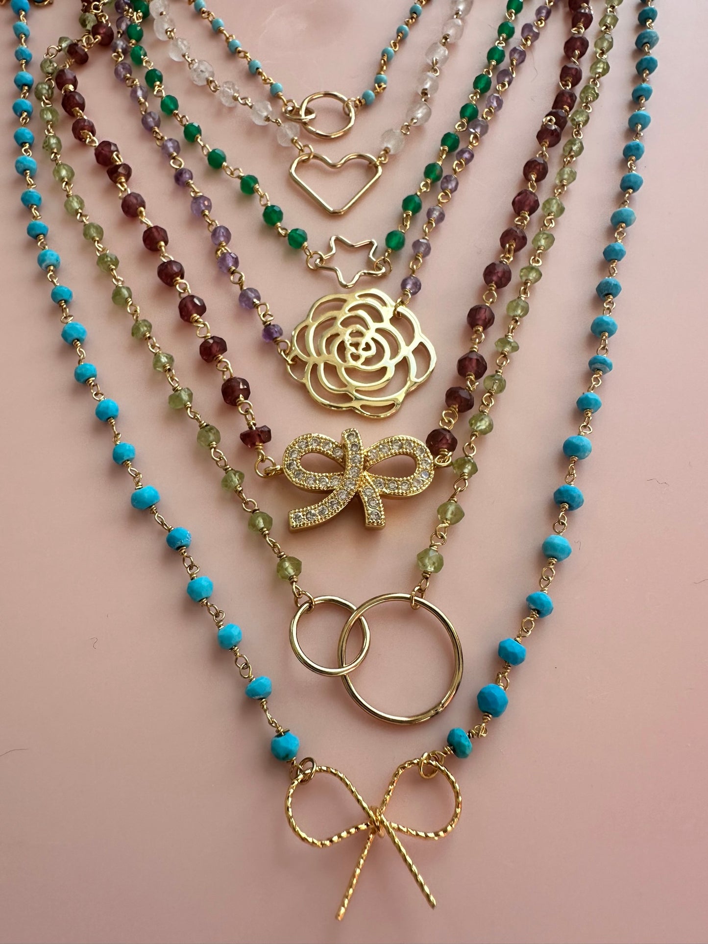 Group of multi coloured rosary gold neckacles