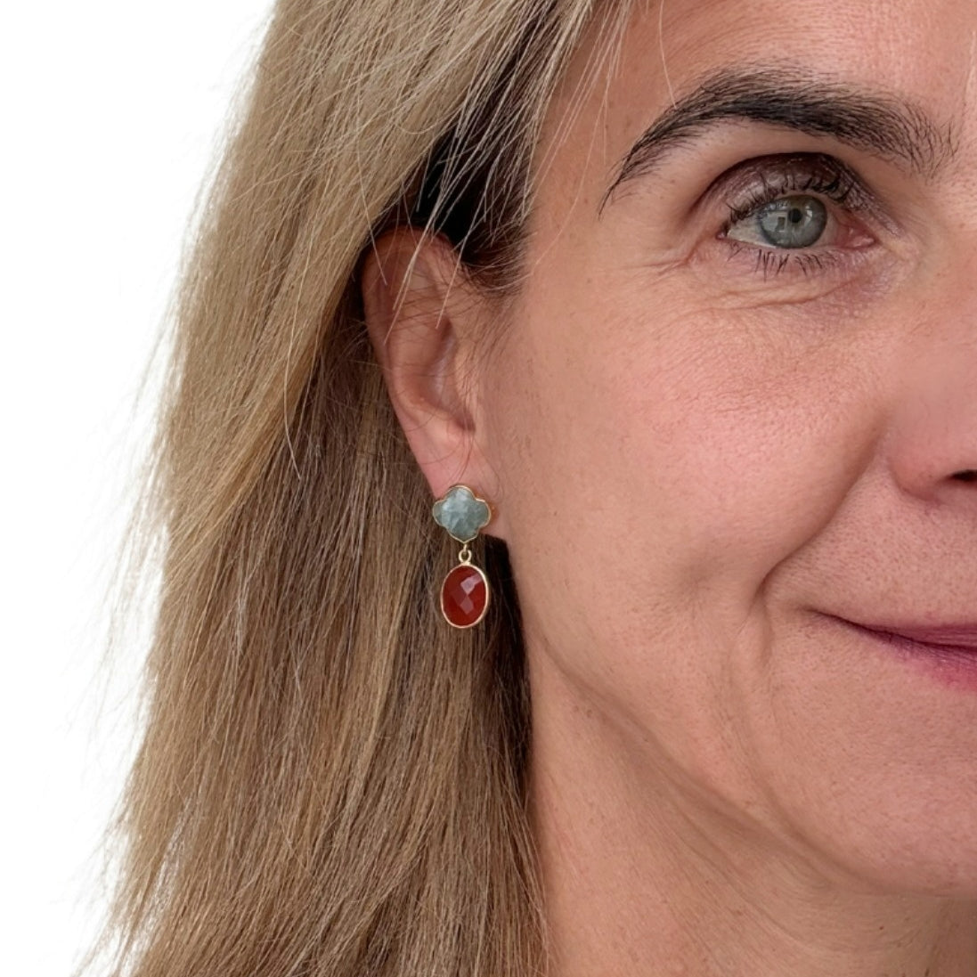 Clover shaped Aventurine semi-precious gemstone studs with oval Carnelian dangling charms worn on model