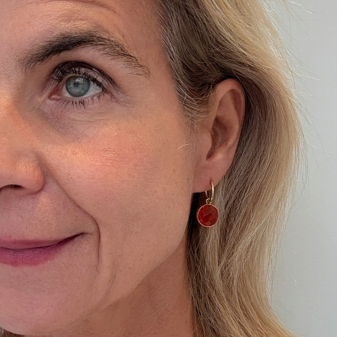 Gold hoopearrings with gorgeous orange quartz round charms on model