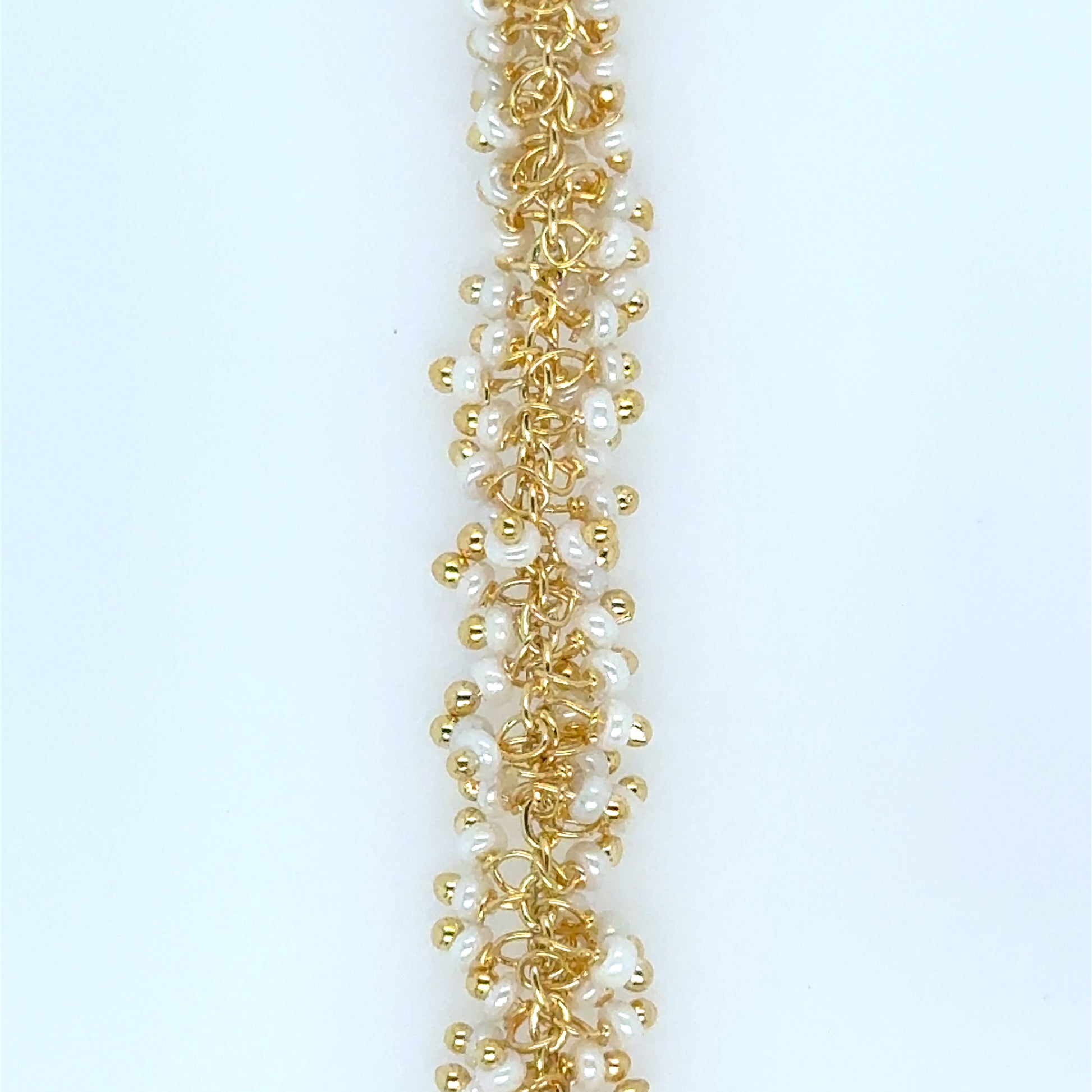 Close up of gold necklace with 2mm pearl beads in grape dangling style.