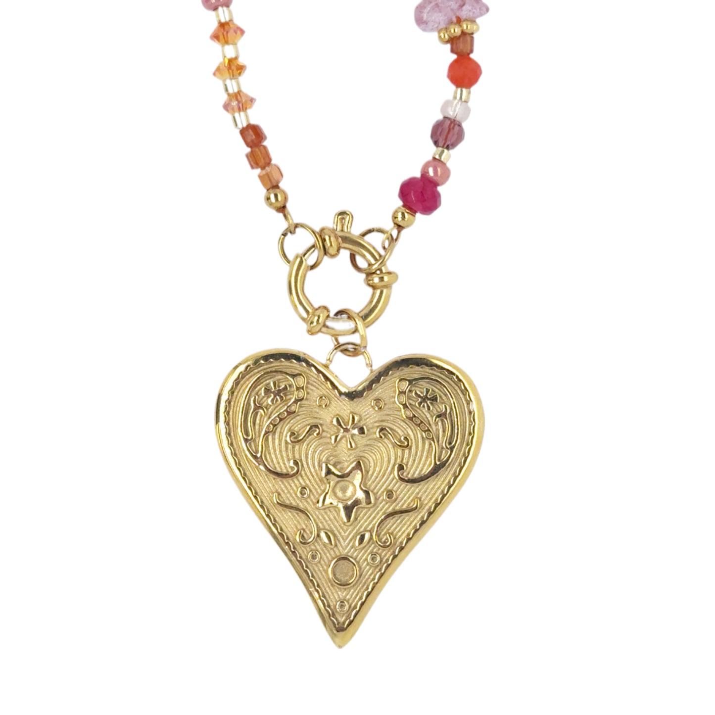 close up of gold patterned heart from a necklace