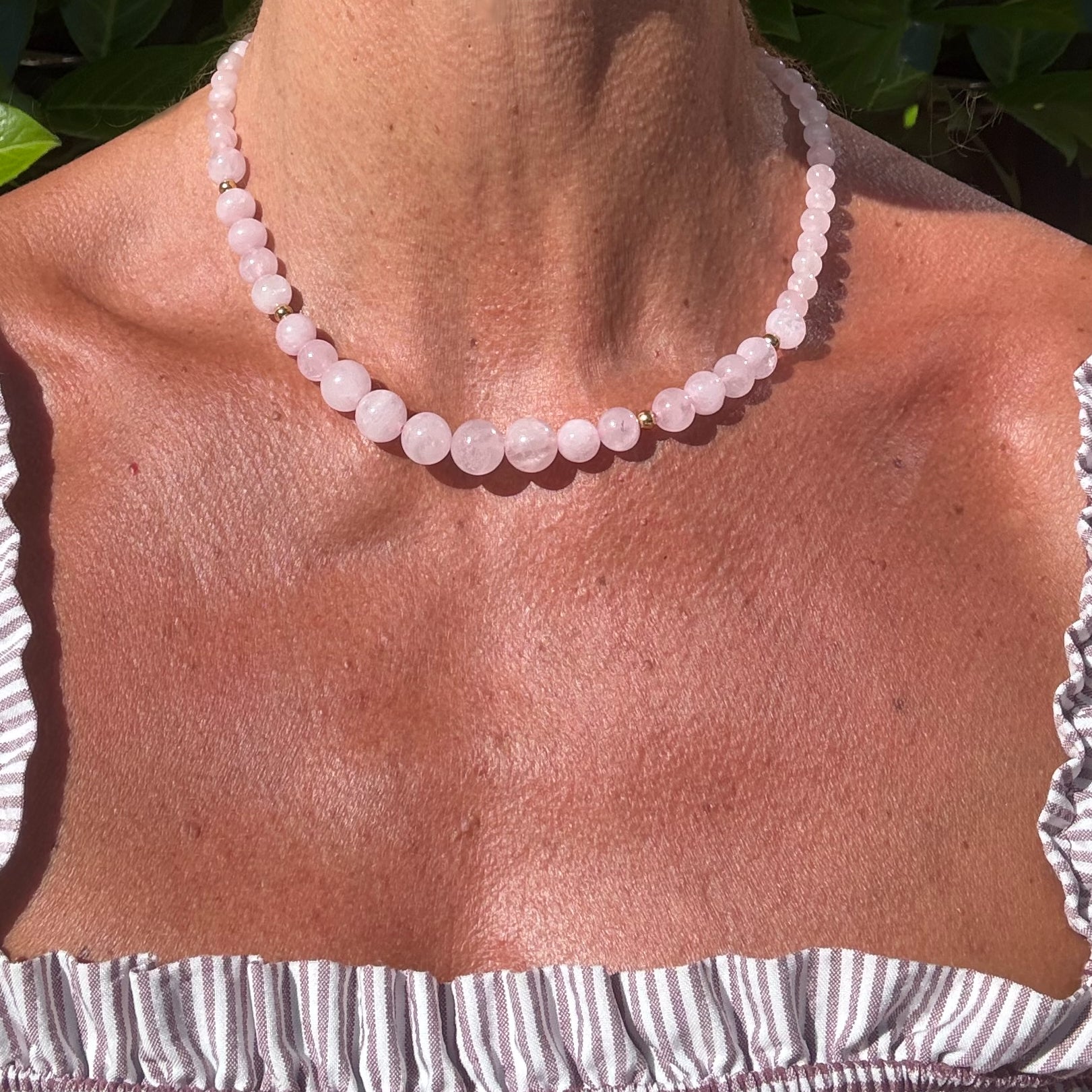 necklace with 6-10mm Rose Quartz gemstone and gold beads on model