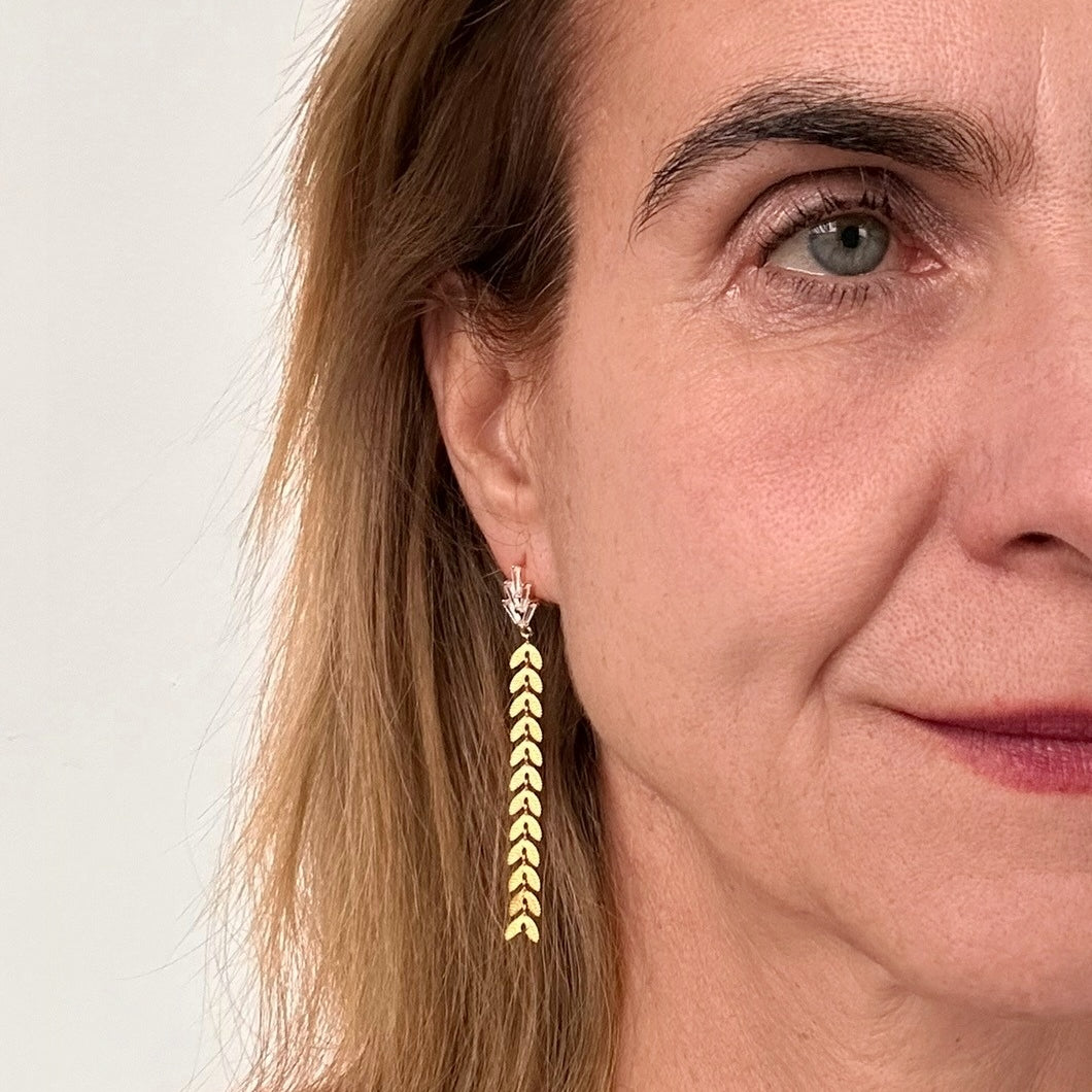 sparkling stud with dangling laurel chain on model