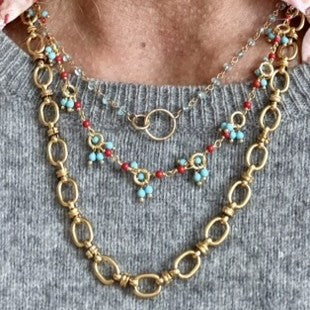 Gold necklace with bright Turquoise and red Coral gemstone beads worn with gold oval chain and blue apatite rosary necklace