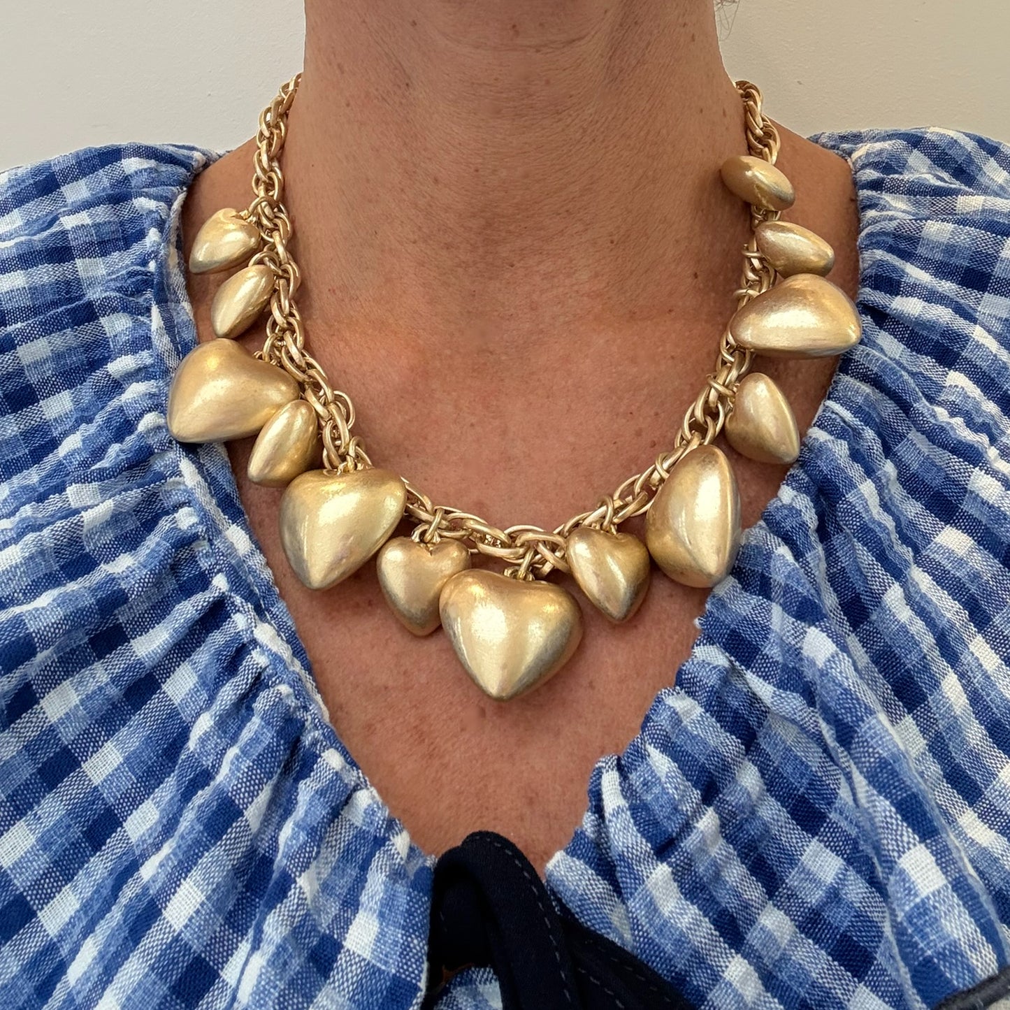 big heart gold necklace worn on woman