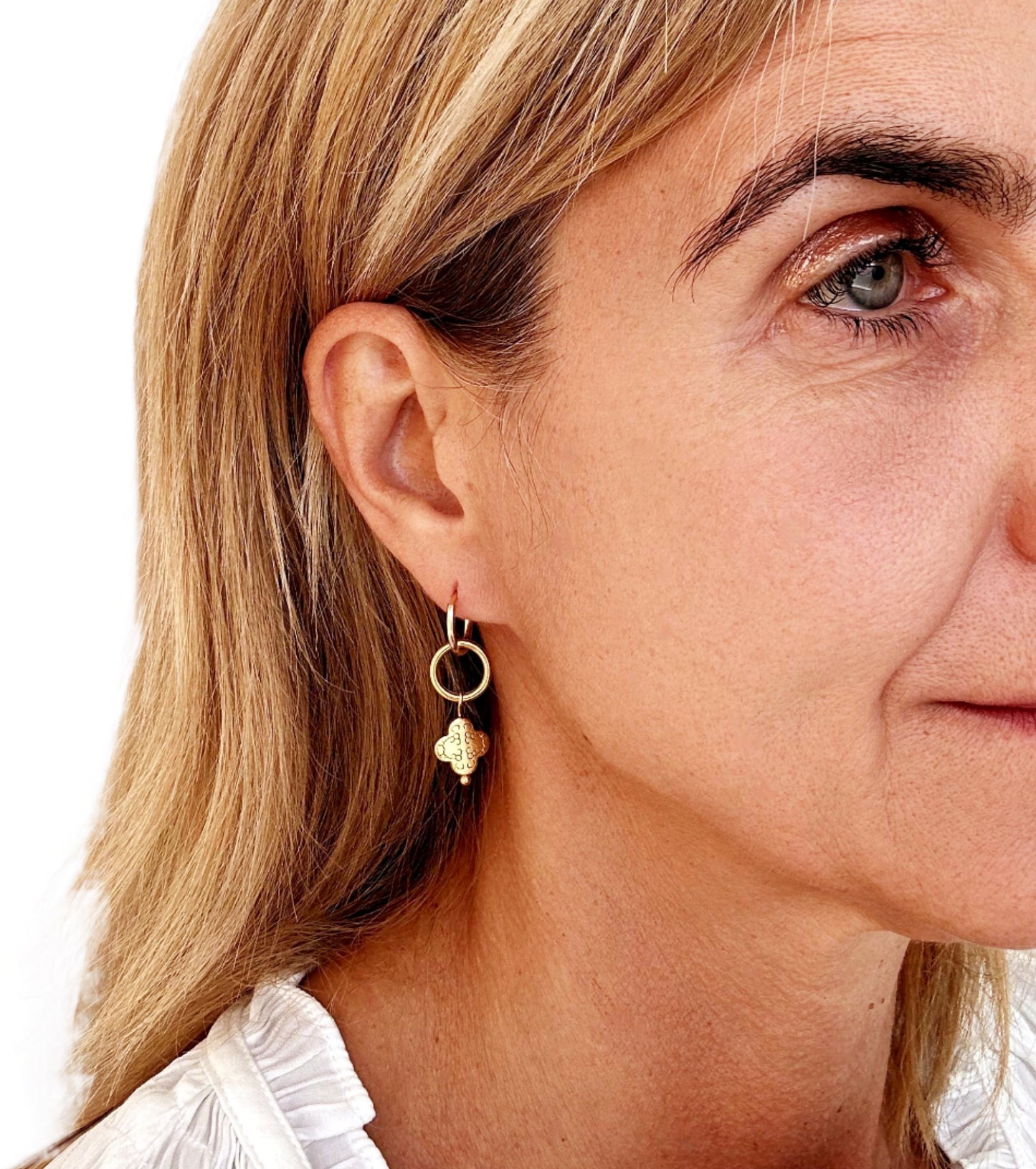 gold hoop earrings with circle and clover gold charms