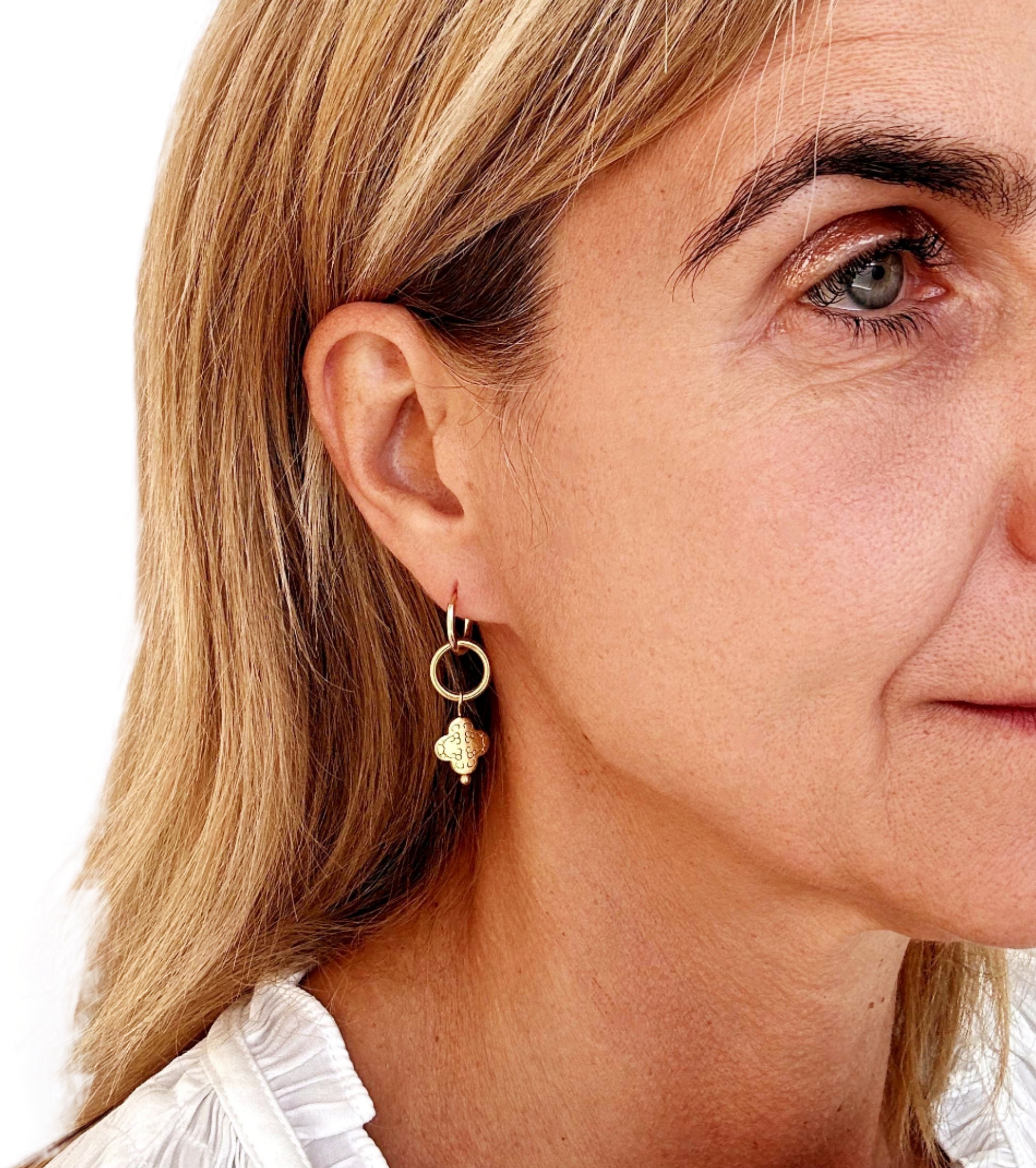 gold hoop earrings with circle and clover gold charms