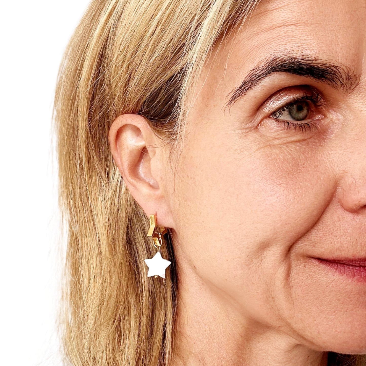 Star shaped gold hoop earrings with star shaped mother of pearl charms