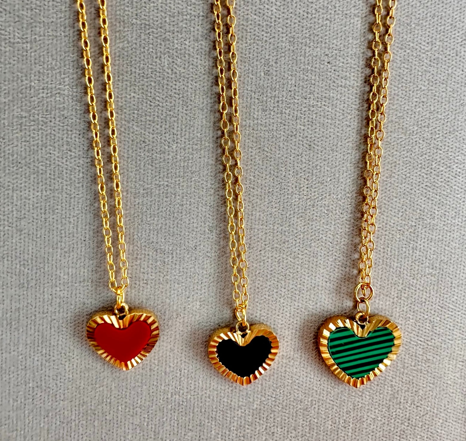 gold chain necklaces with one heart shaped charms in red, black and gold