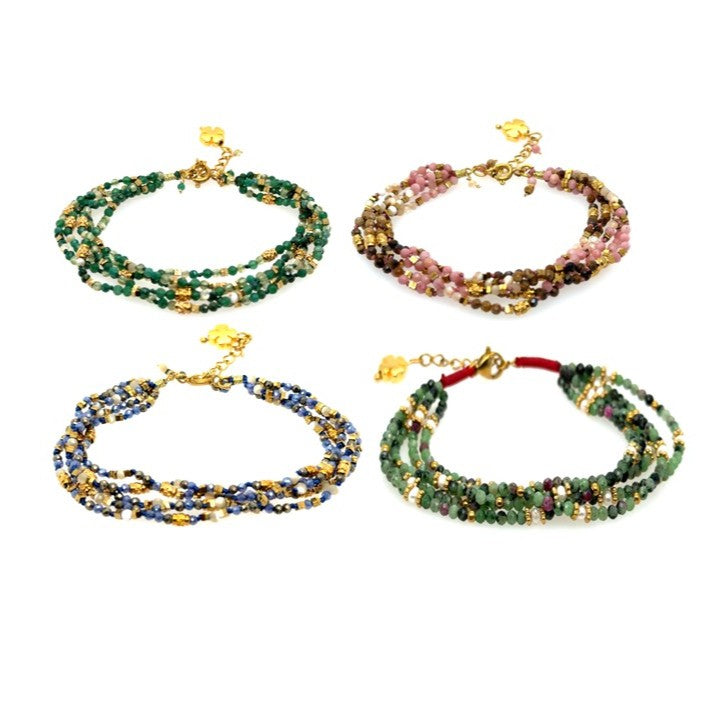 Four multi-strand beaded bracelets on a white background. The bracelets feature gold beads, tiny pearls and bead combinations of green, pink, and blue.