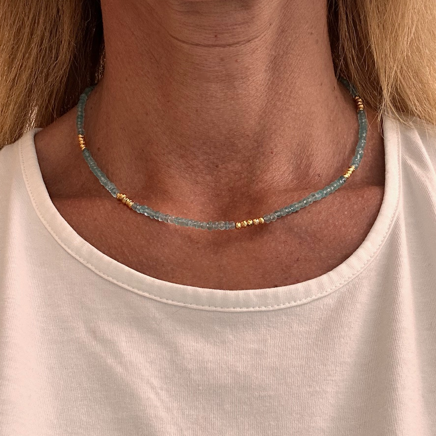 Necklace with lovely blue Apatite beads and bright golden pyrite beads all around worn on model