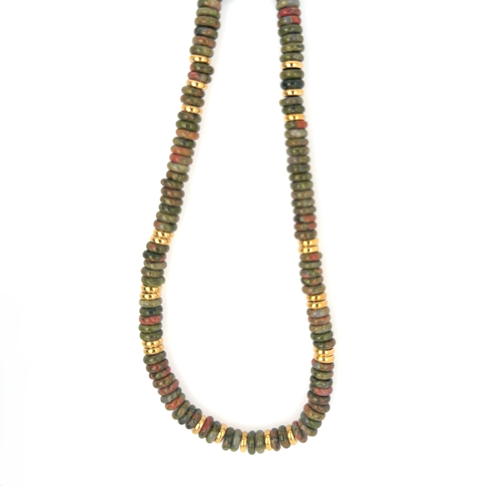 Necklace with green and gold beads on a white background