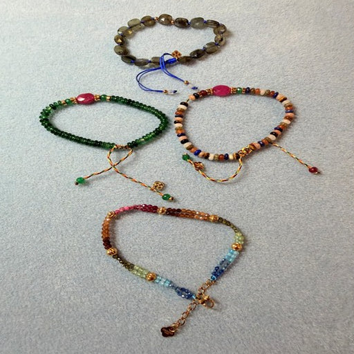 Four colourful gemstone string bracelets 