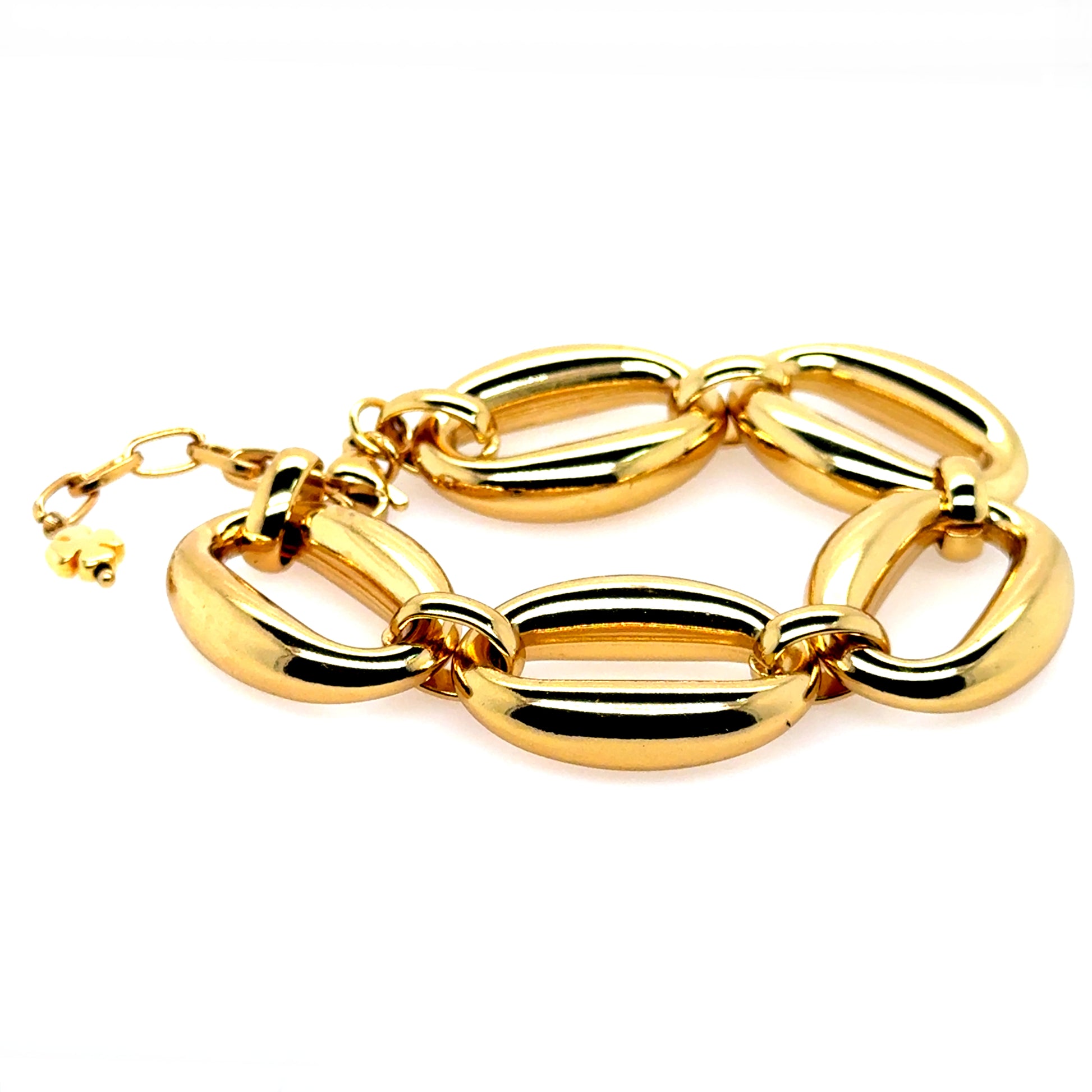 Gold bracelet with big wide links and small clover for good luck