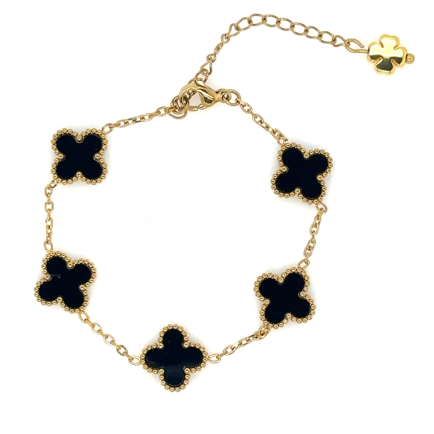 gold bracelet has five small clover charms in black enamel