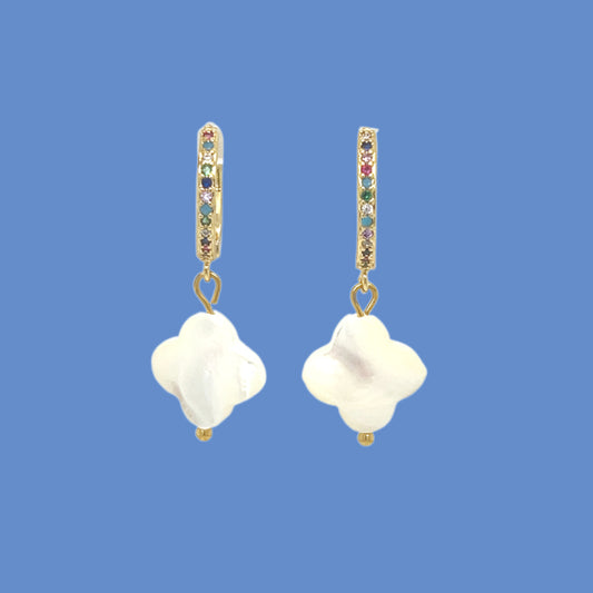 Gold hoop earrings with rainbow zirconia stones and clover-shaped shell charms in white mother of pearl.