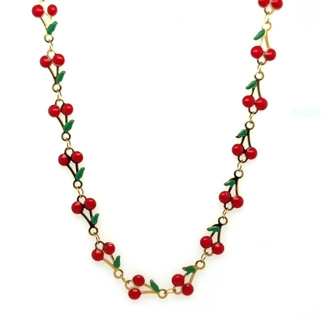 Necklace with red cherries and gold chain on a white background