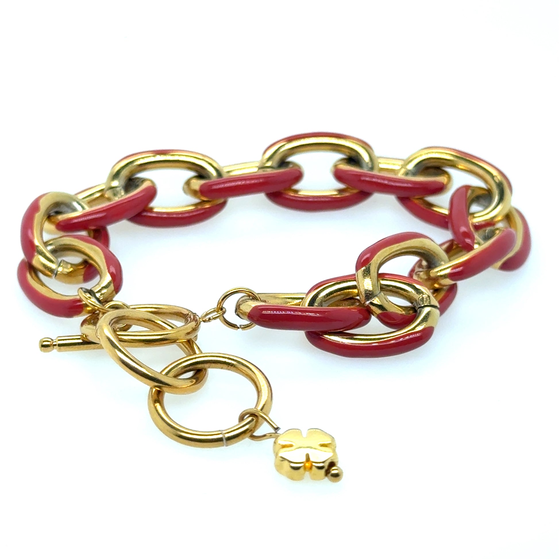 This lovely chunky gold bracelet has wide links which have red enamel painted on one side. 