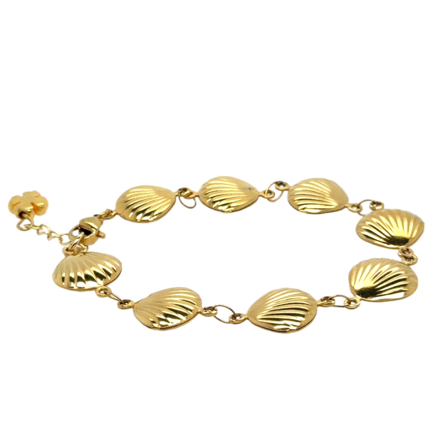 Gold bracelet with shell-shaped links on a white background
