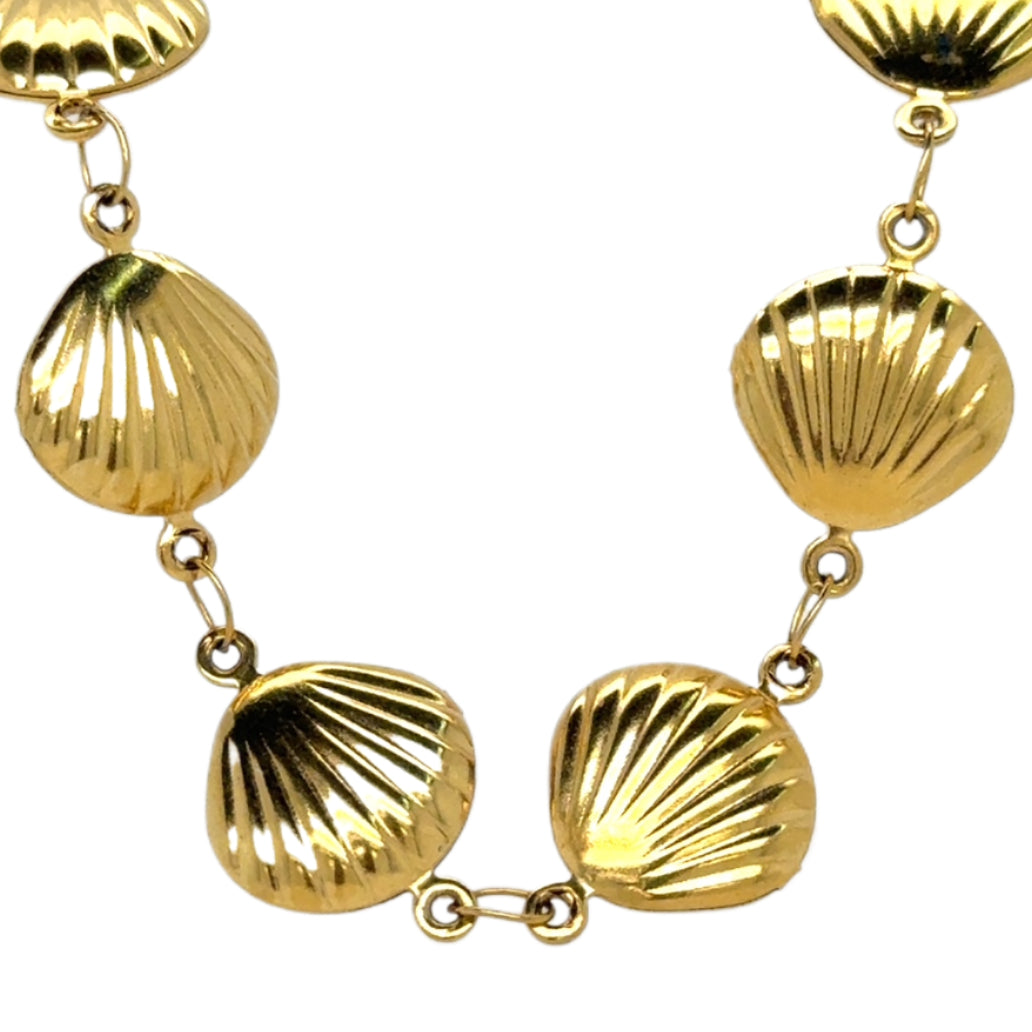 Gold shell-shaped bracelet on a white background