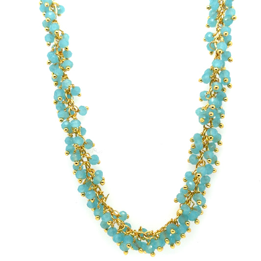 Gold necklace with Blue Chalcedony gemstone beads arranged in dangling clusters