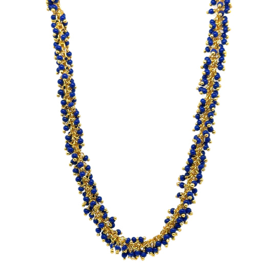 Delicate gold hoops with bright navy blue glass beads arranged in dangling clusters