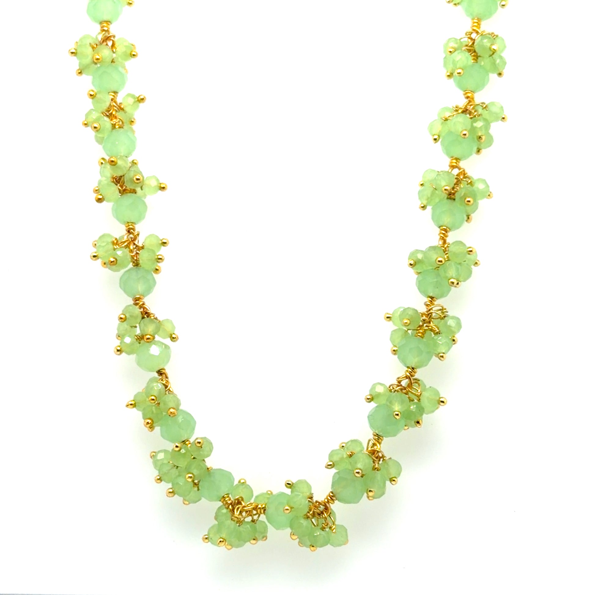 Gold necklace with Prehnite gemstones arranged in big dangling clusters.