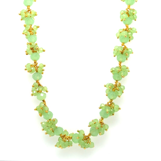 Gold necklace with Prehnite gemstones arranged in big dangling clusters.