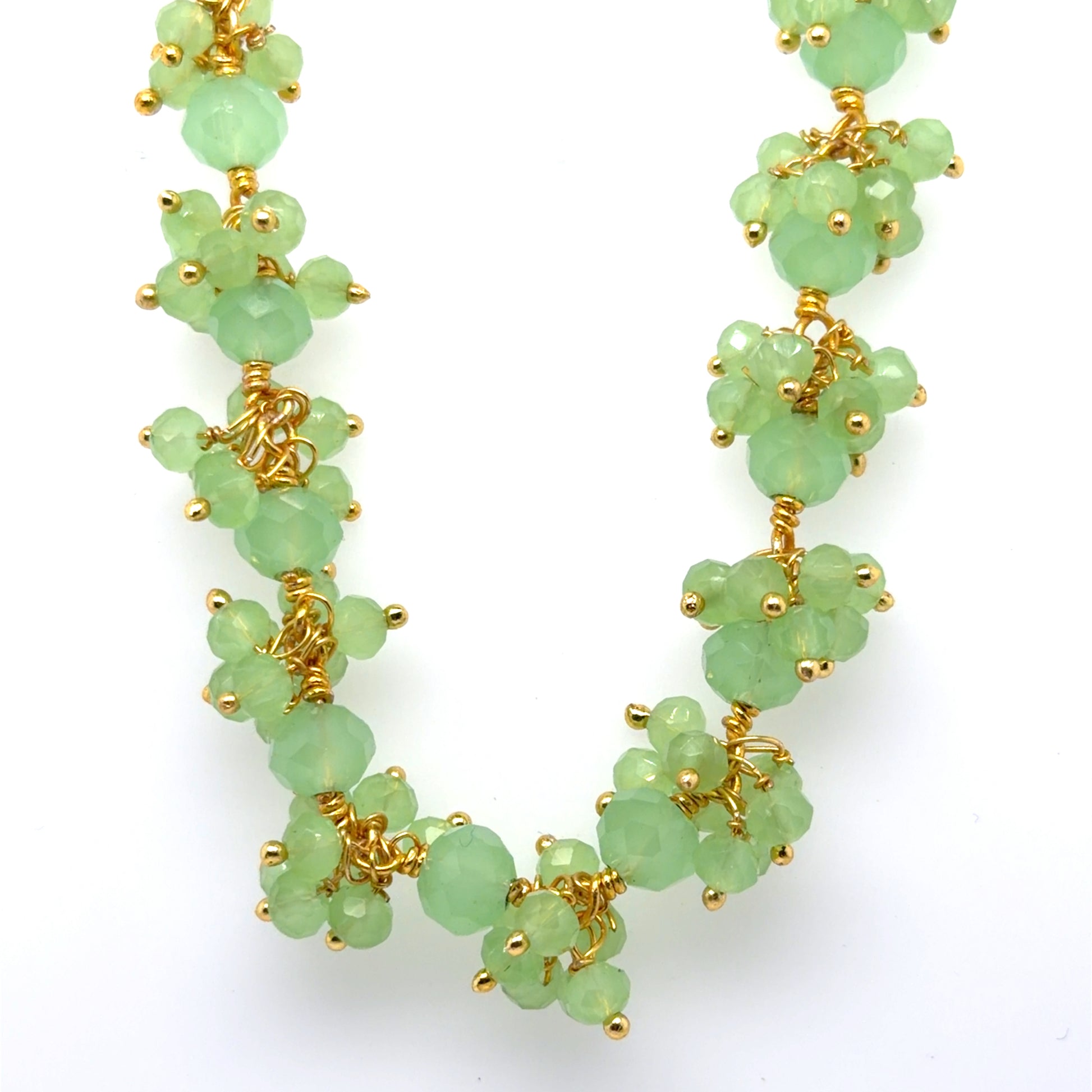 Necklace with green gemstones on a white background