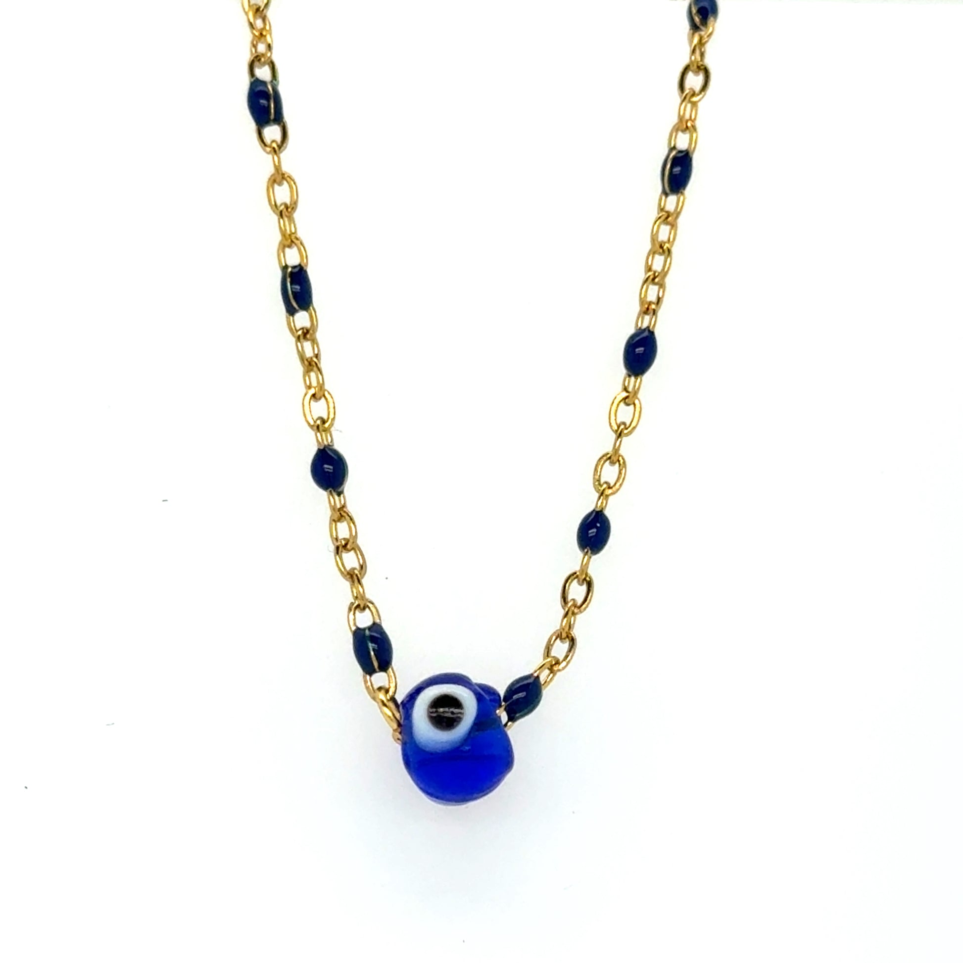 Bracelet with blue evil eye bead on a gold chain against a white background