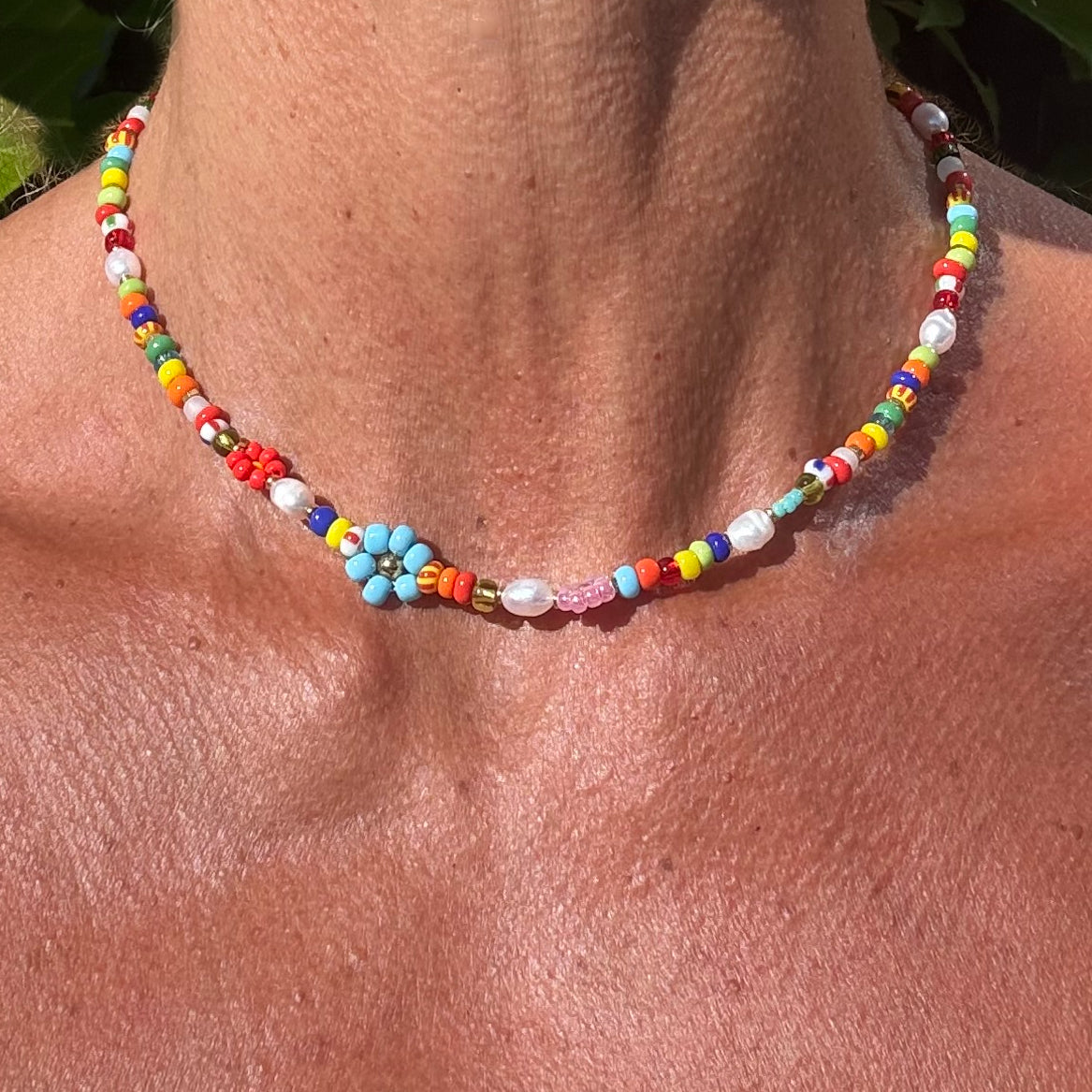 Colorful beaded necklace on a person's neck