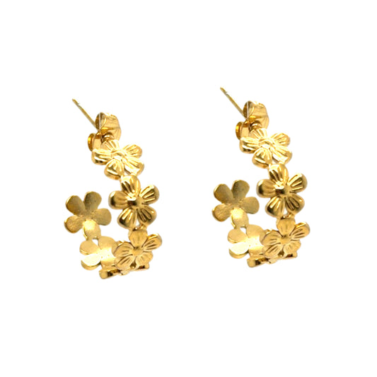 Gold floral hoop earrings on a white background