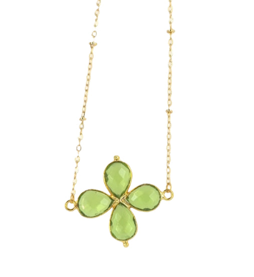 Delicate gold chain necklace with a Peridot gemstone four petal flower shaped charm