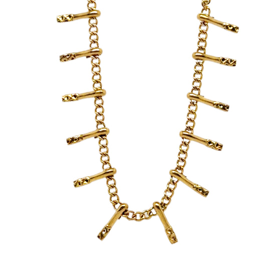 Gold chain bracelet with bar-like links on a white background