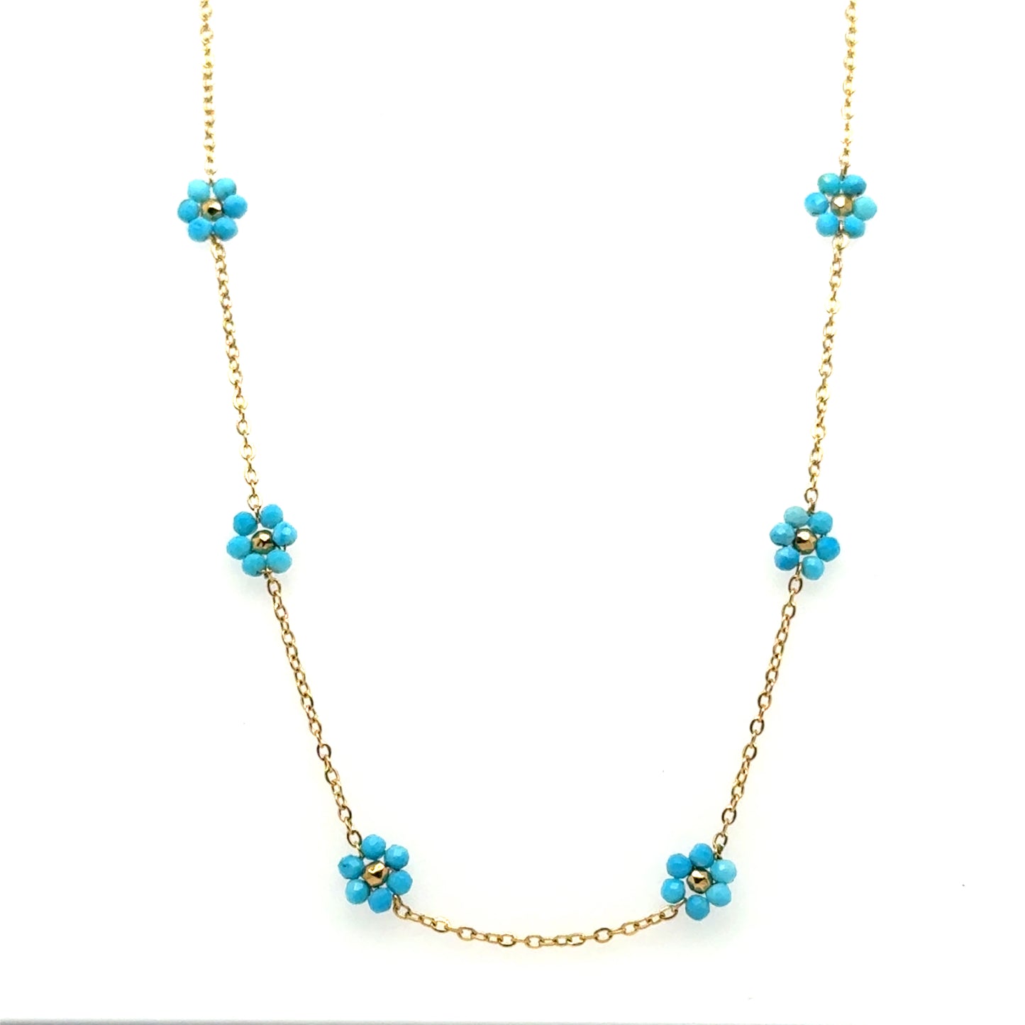 Necklace with five small turquoise and gold flowers on a delicate chain