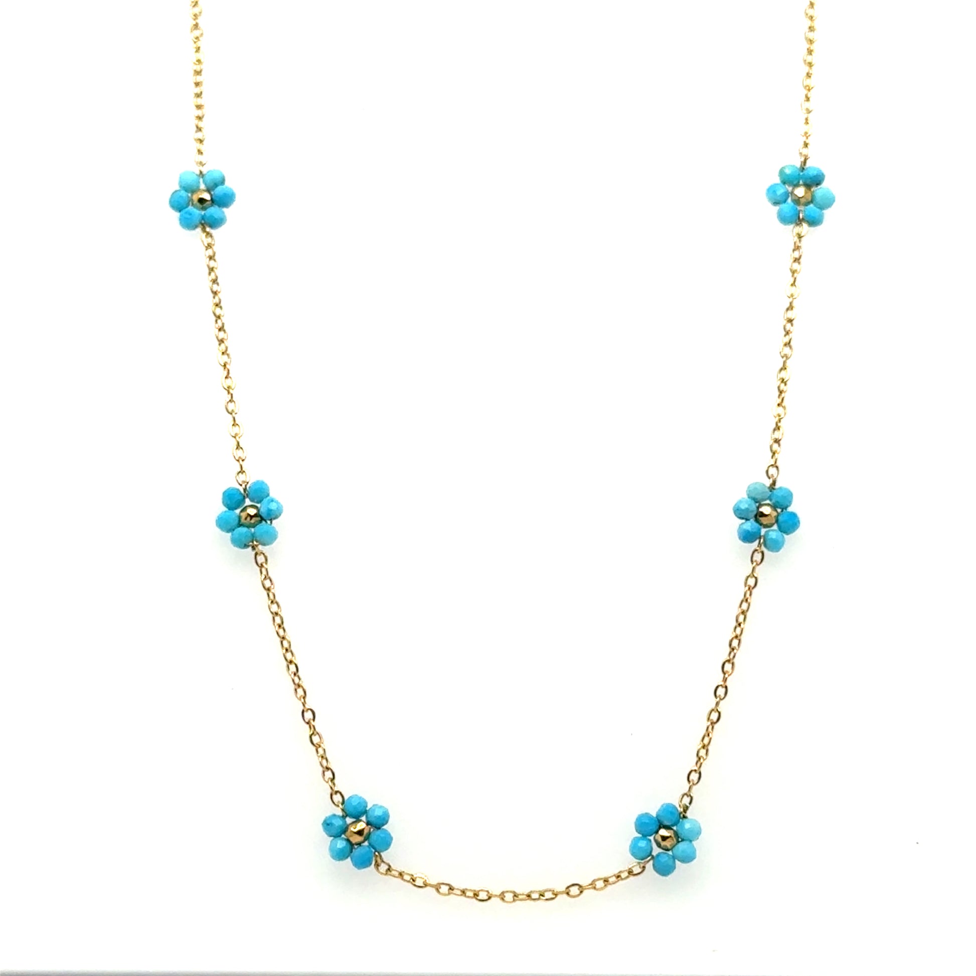 Necklace with five small turquoise and gold flowers on a delicate chain