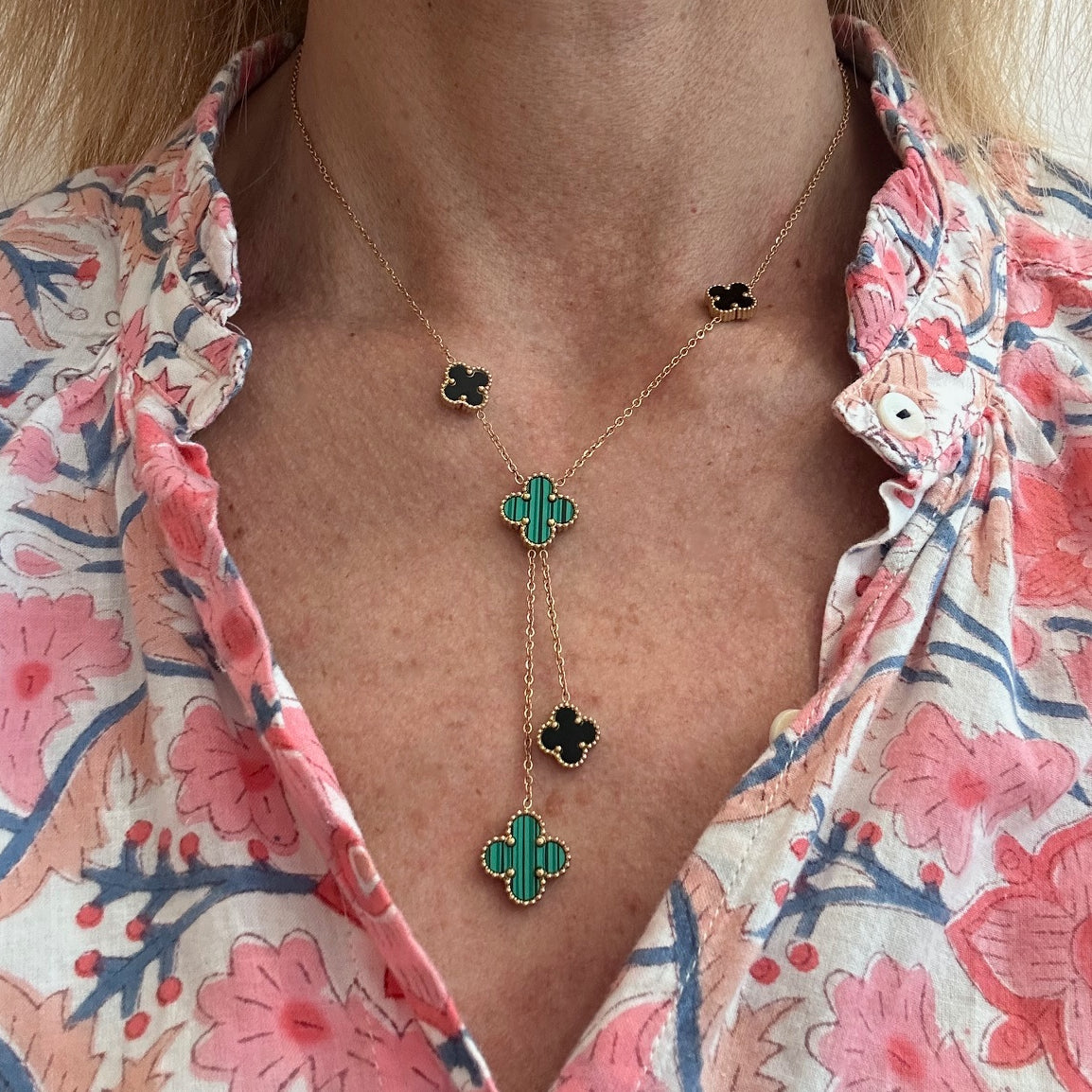 Lariat necklace with five small and medium sized reversible clover charms in black and green