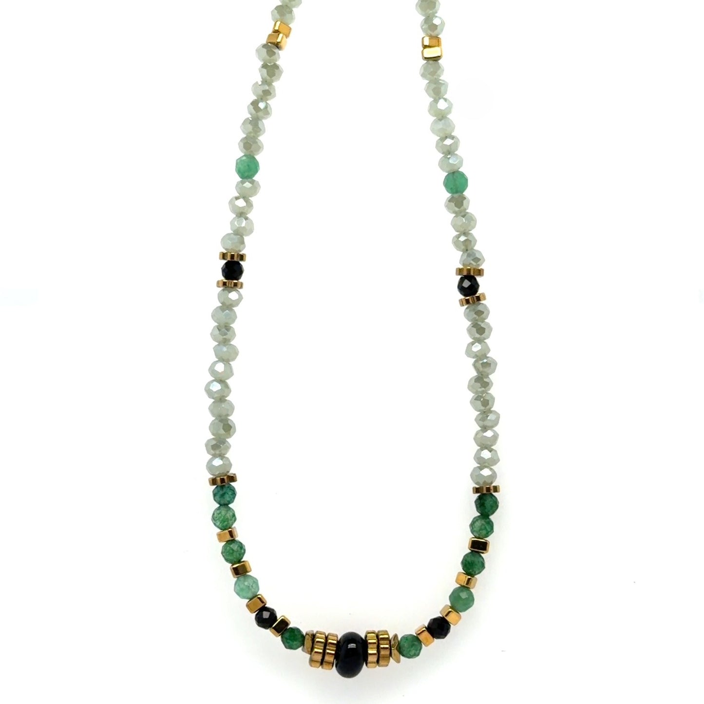 Delicate necklace with tiny black and gold beads, and dangling small sparkly clover charm