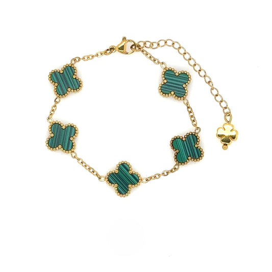 gold bracelet has five small clover charms in green enamel