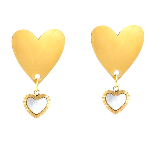 Gold heart-shaped earrings with a smaller white heart pendant on a white background