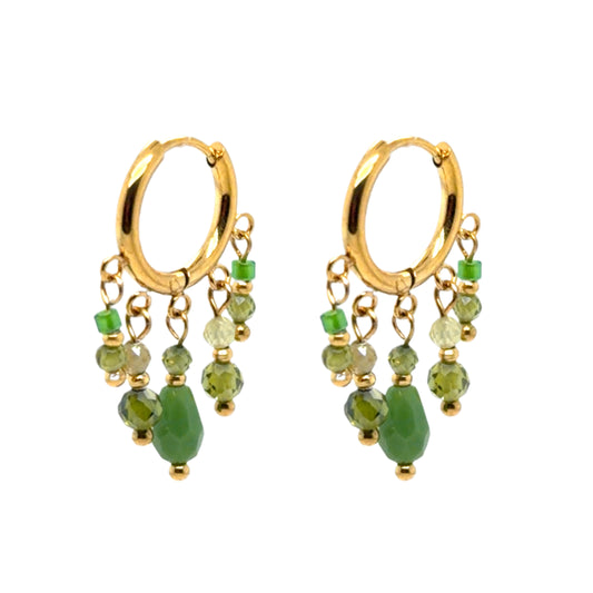 Huggie gold hoop earrings with small green charms