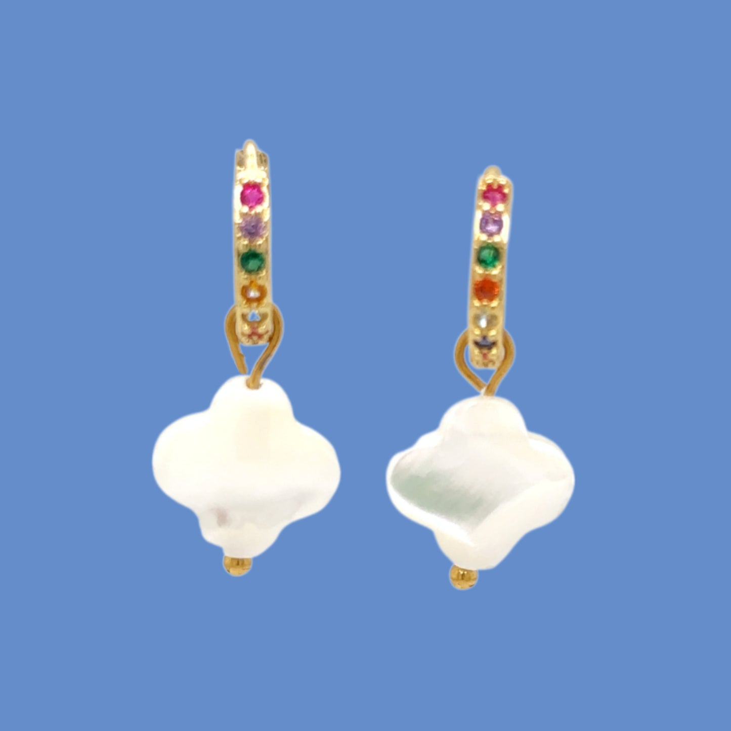 Huggie gold hoop earrings with rainbow zirconia stones and clover shaped charm in white mother of pearl shell